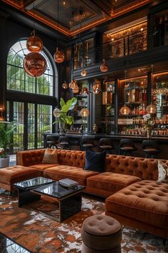 a living room filled with lots of furniture next to a window covered in plants and hanging lights