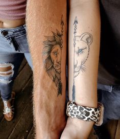 two people with tattoos on their arms holding each other's hands, one has a lion and the other has a cheetah