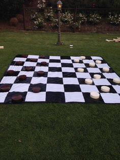 a black and white checkered board game in the grass