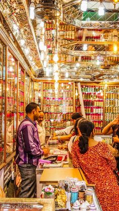 people standing around in a store looking at items