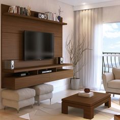 a living room with a large tv mounted on the wall and speakers in front of it