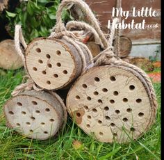 four wooden logs stacked on top of each other in the grass with text overlay that reads, my little habitat