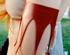 a woman with blood dripping down her leg