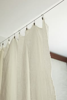 white curtains hanging from a line in a room