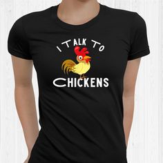 a woman wearing a black t - shirt with the words i talk to chickens on it