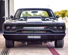 the front end of a black muscle car