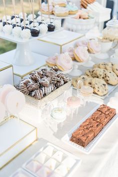 an assortment of desserts and pastries are on display at a wedding or bridal party