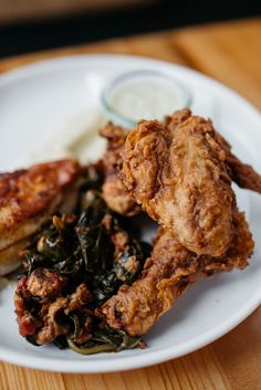 fried chicken and greens on a white plate