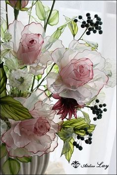 a vase filled with pink and white flowers