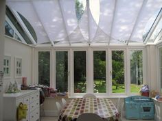 a sun room with a table and chairs in it