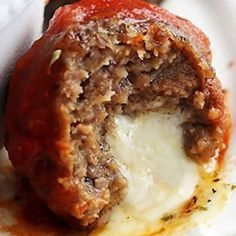 the meatball is stuffed with cheese and sauce