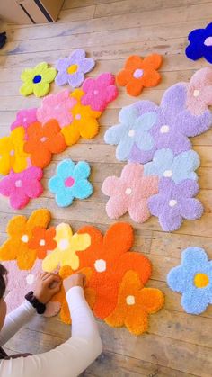 a child is making flower rugs on the floor