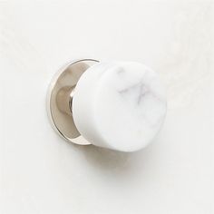 an image of a white marbled knob on a doorknobl or cabinet