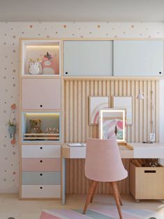 a pink chair sitting in front of a desk