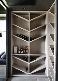 an open bookcase with wine bottles in it