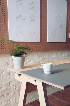 a table with a cup and plant on it