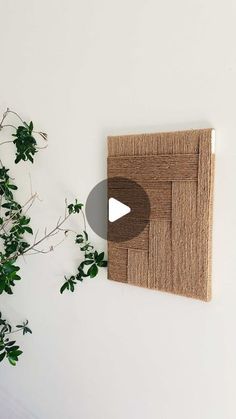 a white wall with a plant and a video screen