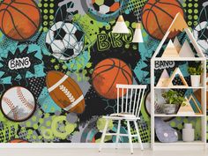 sports balls and basketballs are depicted on this colorful wallpapered children's room