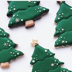 christmas cookies decorated with green and white icing are arranged in the shape of trees