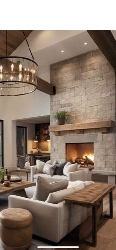 a living room filled with furniture and a fire place in the middle of a room