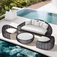 an outdoor furniture set sitting next to a swimming pool