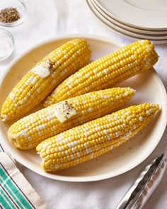 grilled corn on the cob with butter and seasoning sitting on a plate