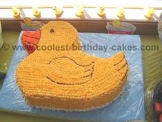 a large yellow duck cake sitting on top of a table