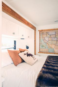 a bedroom with a map on the wall