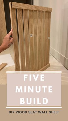 a hand holding a wooden slat with the words five minute build in front of it