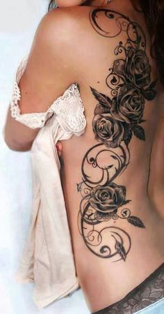 a woman's back with roses and leaves on it, in the pages of a magazine