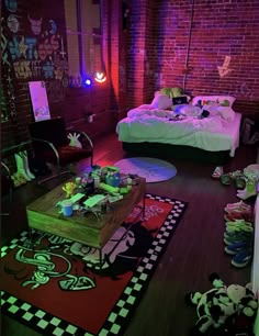 a room with a bed, rugs and other items on the floor in front of a brick wall