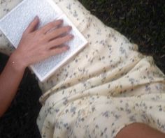 a person laying on the ground using a laptop computer with their hands resting on it