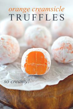 orange creamsicle truffles on a wooden platter with text overlay