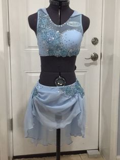 a mannequin wearing a blue dress with sequins on it