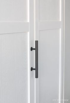 an open white door with a black handle