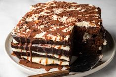 a chocolate cake with white frosting on a plate