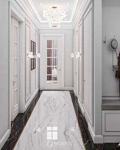 an elegant hallway with marble floors and white walls, along with chandelier lights