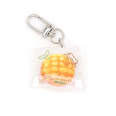 a keychain with a piece of corn on the cob printed on it