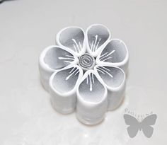 a white flower shaped object sitting on top of a table