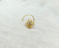 Name of Product: 18Carat Gold Nose Pin / Gold Nose Ring  Unfortunately no exchanges /refunds due to hygiene reasons Material: Gold Weight: 290 Milligrams Diameter: .55cm Wire Gauge:  24 Gemstone: Cubic Zirconia  -----Feedback::- A satisfied customer is our top priority and your feedback forms the backbone of our success. Don't forget to give positive feedback along with good ratings. Thank You Wire Nose Ring, Nose Pin Gold, Nose Ring Gold, Gold Nose Pin, Gold Nose Ring, Wire Gauge, Gold Nose Rings, Nose Pin, Nose Ring Stud