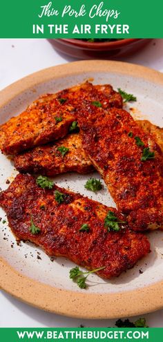 there are two pieces of fish on the plate with parsley in the air fryer