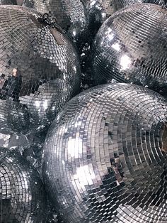 many shiny disco balls are stacked on top of each other