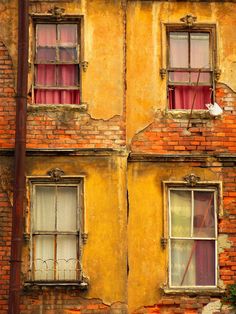 an old brick building with two windows