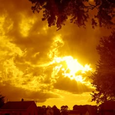 the sun shines brightly through clouds over houses