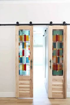 two wooden doors with stained glass panels on them