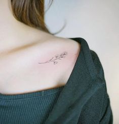 a woman with a small tattoo on her shoulder