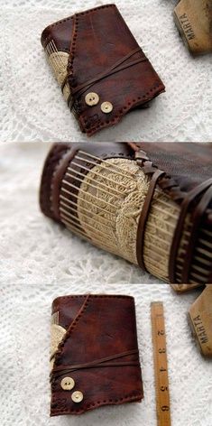 some kind of leather case sitting on top of a white cloth covered table next to a ruler