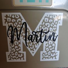 the letter m is made up of leopard print and black letters that spell out'm '