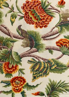 green and orange indian-inspired botanical printed fabric with a cream background