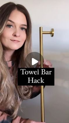 a woman holding a towel bar in her hand and the words towel bar hack on it